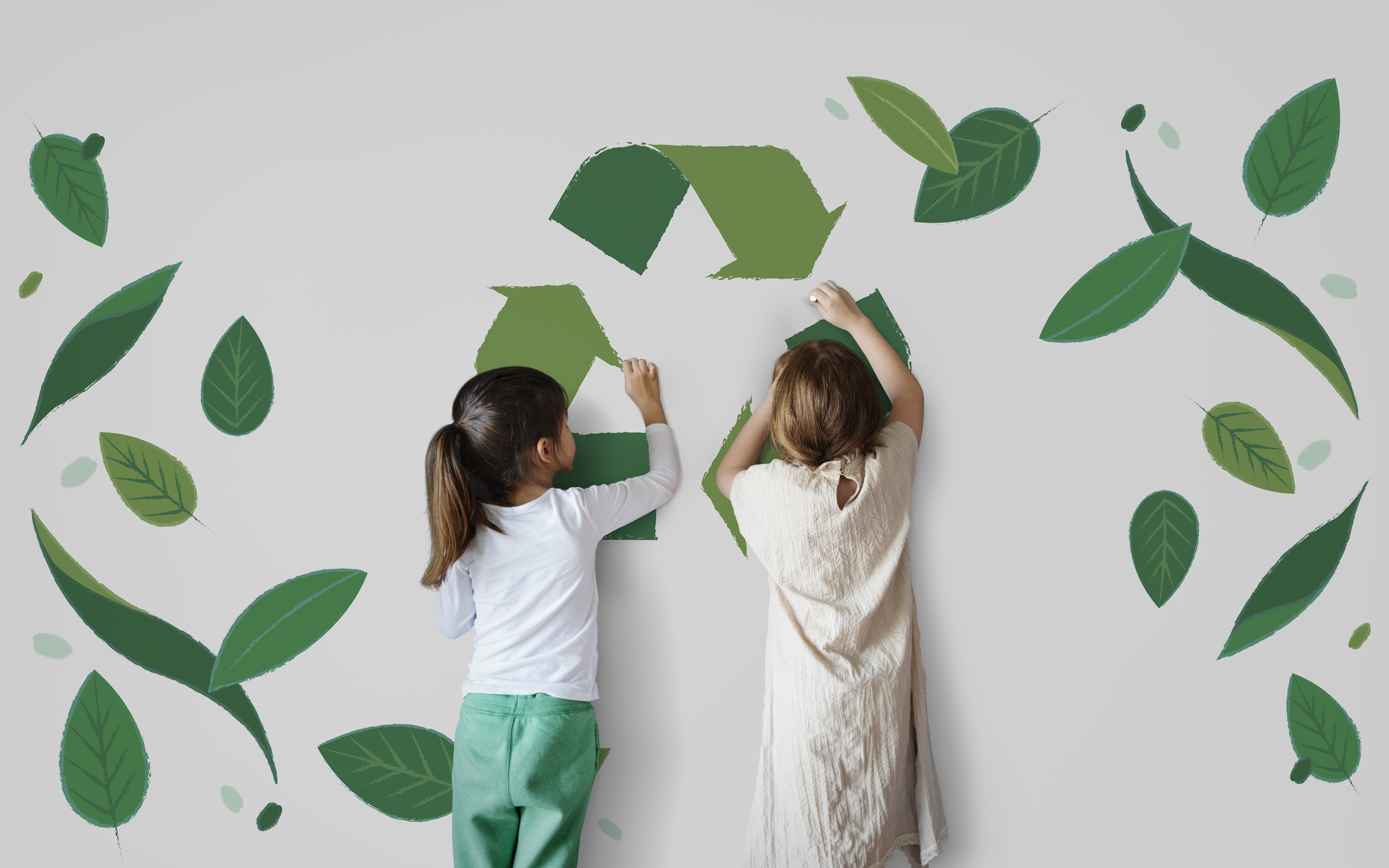 Two children stand facing a wall, attaching green cutouts that create a recycling symbol; decorative leaf illustrations scatter around them on a light background.