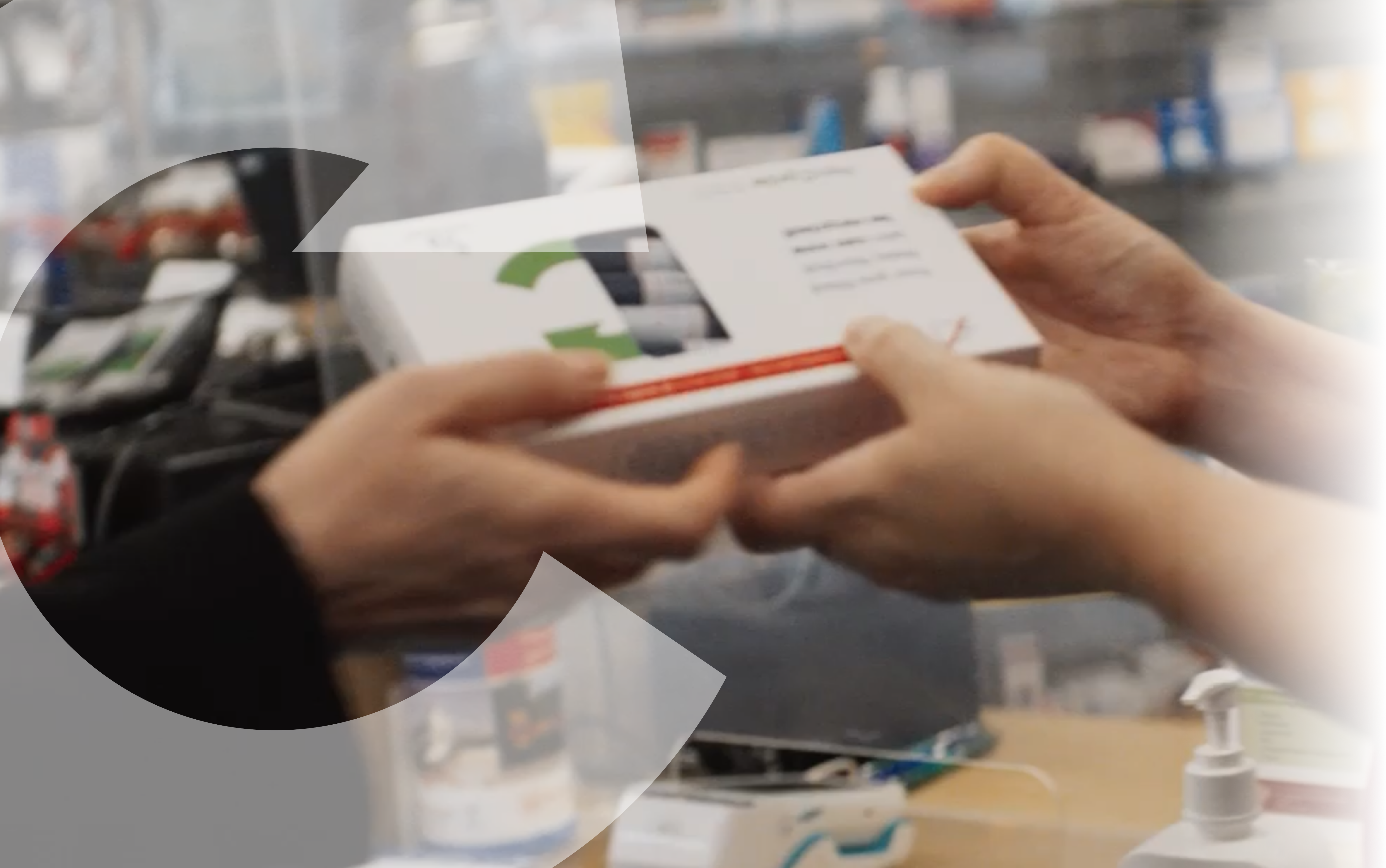 A person’s hands giving a white box to another person’s hands.